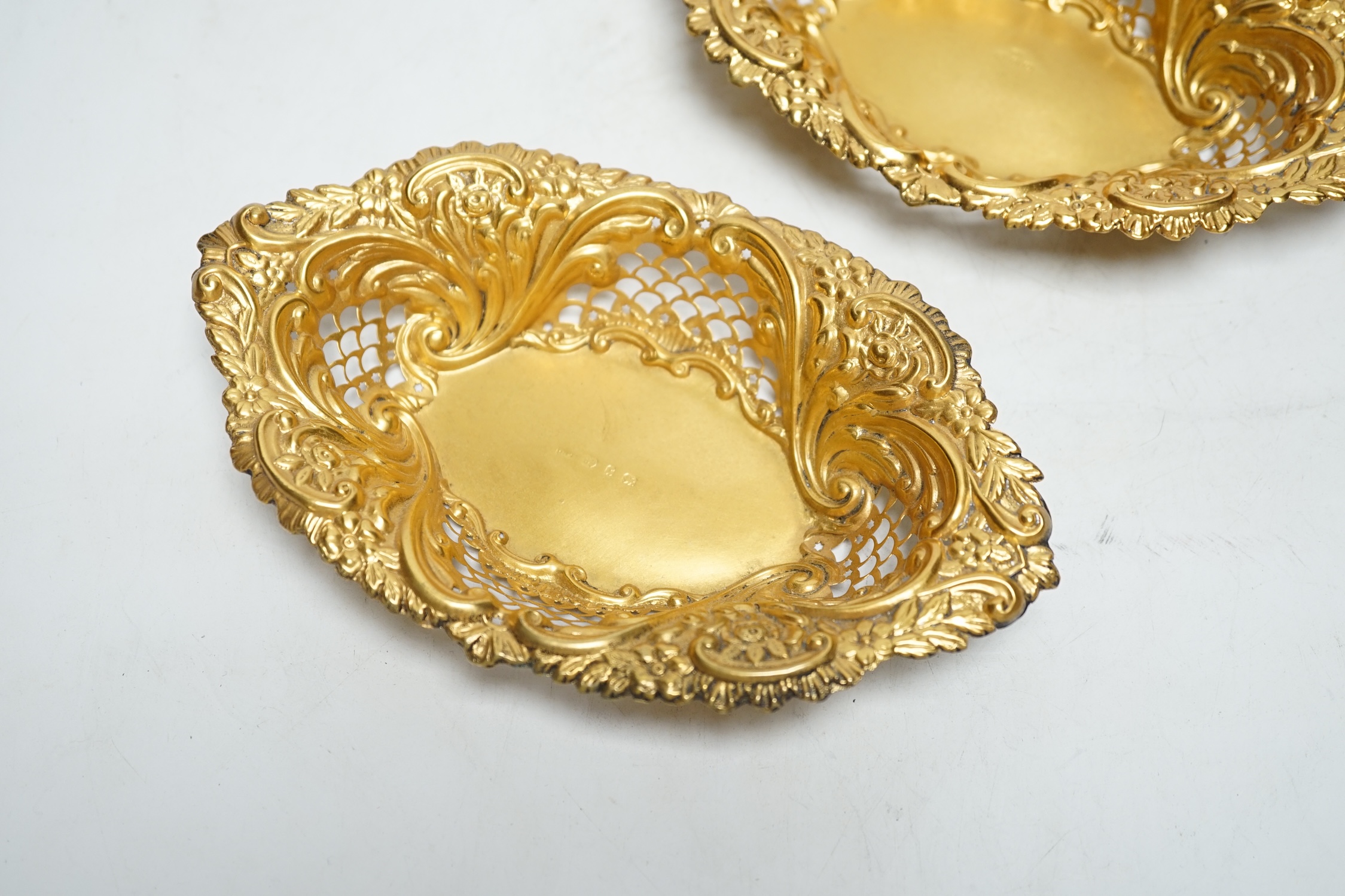 A pair of late Victorian matt finish pierced repousse silver gilt oval dishes, Birmingham, 1897, 18.2cm, 3.5oz